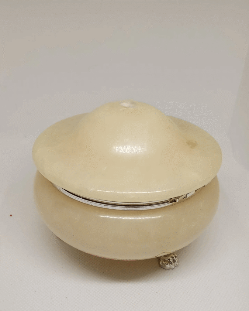 a white round object with a silver rim
